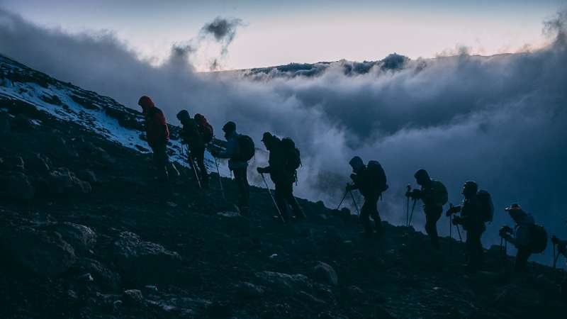 Why climb Kilimanjaro at night? Firmer trails, better acclimatization, avoid harsh sun, and witness a sunrise from the crater rim.